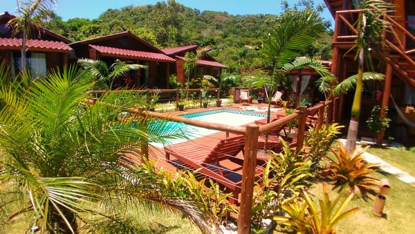a patio with a pool and a pool table at ॐ Rosa Astral ॐ in Praia do Rosa