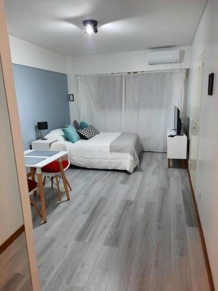 1 dormitorio con cama, mesa y escritorio en Amb Libertador en Buenos Aires