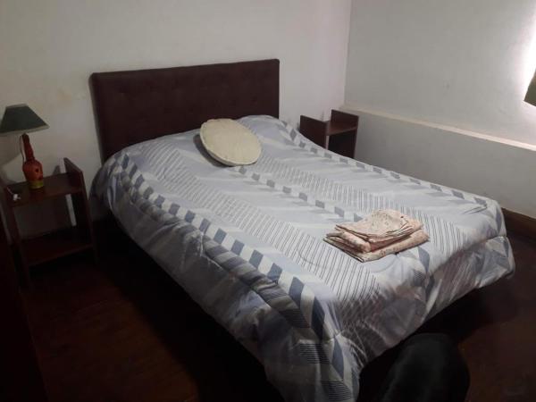 a bed with a hat and towels on it at deptos temporarios carlos y yanina in Santa Fe