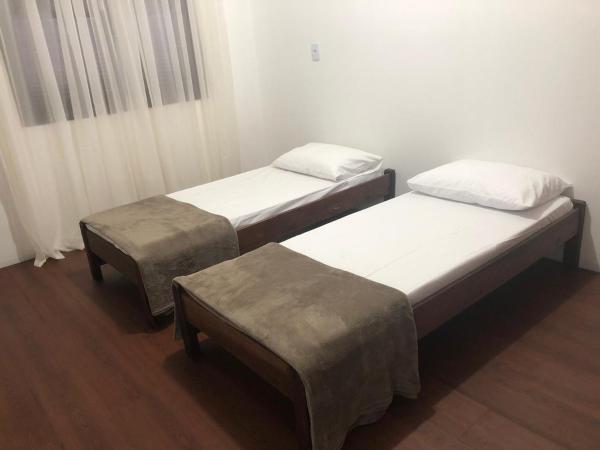 Cama o camas de una habitación en São Pedro hospedaria