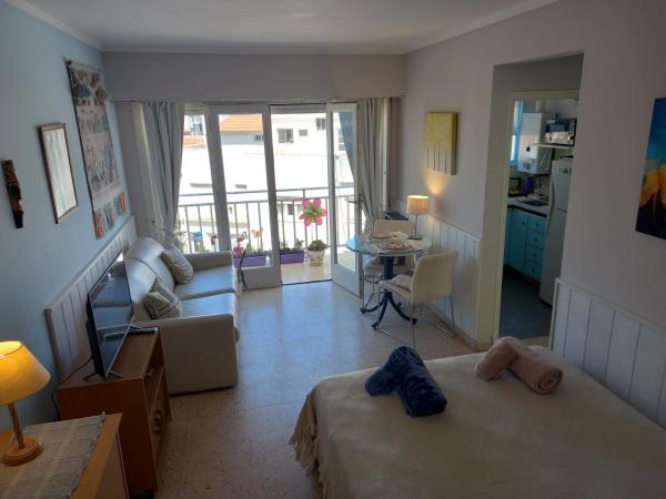 1 dormitorio con 2 camas y sala de estar con balcón. en DESCANSO IDEAL II CABO CORRIENTES en Mar del Plata