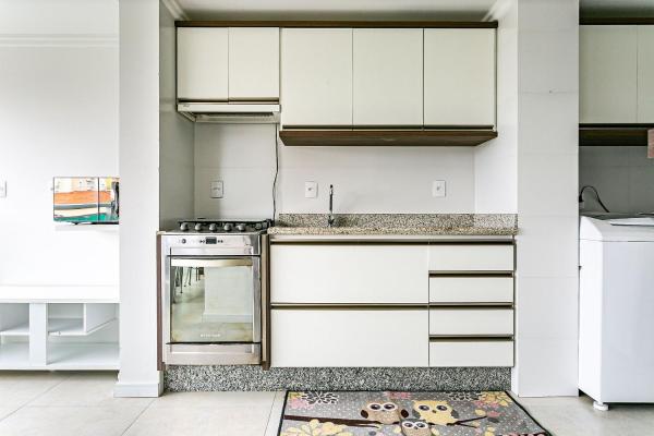 a kitchen with white cabinets and a stove at Apto com duas suítes no Open Shopping CPJ304 in Florianópolis