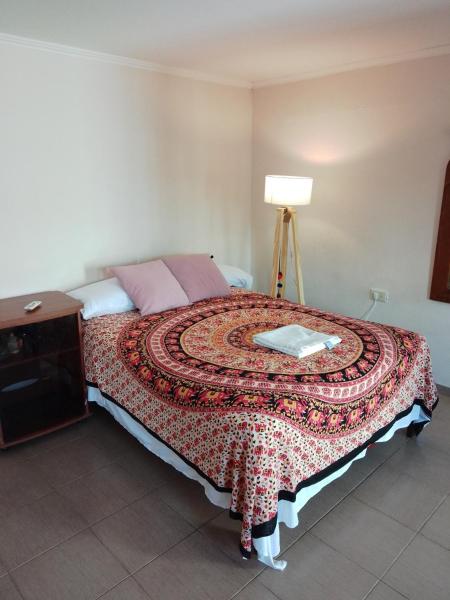 a bedroom with a bed with a quilt on it at Departamento Boulevard Santa Fe in Santa Fe