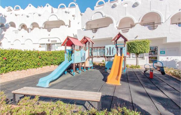 un parque infantil frente a un edificio en Impresionante casa en Marbella con piscina al aire libre, WiFi y 2 habitaciones, en Marbella