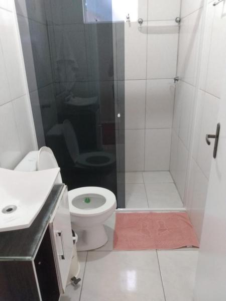a bathroom with a shower with a toilet and a sink at Casa na Praia de Ingleses in Florianópolis