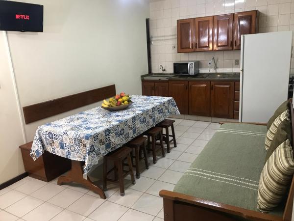 a kitchen with a table with a bowl of fruit on it at Regina del mare apartamento de 02 dormitorios para até 06 pessoas a 50 mts da praia in Florianópolis