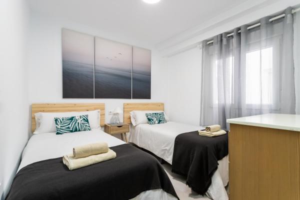 Cama o camas de una habitación en Sur Suites La Peseta