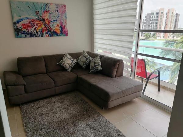 Sofá marrón en la sala de estar con ventana a Un Paraíso en Cancún Dreams Lagoon, en Cancún