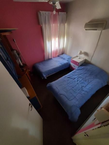 2 camas en una habitación pequeña con ventana en Departamento Cordoba y Urquiza en San Juan