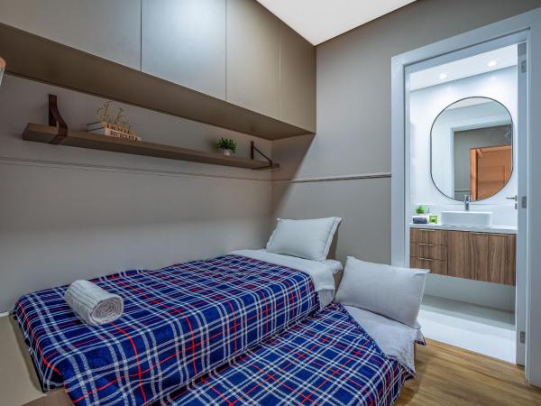 Cama o camas de una habitación en Alpes da Montanha 203 - Apto novo junto ao Centro de Gramado com garagem