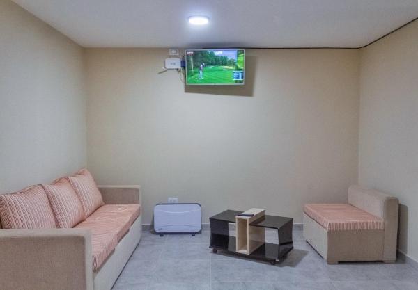 sala de estar con sofá y TV en la pared en CIELO de Jujuy ll en San Salvador de Jujuy