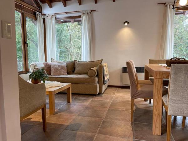 sala de estar con sofá y mesa en Bella casa cercana al centro de ski y playas. en San Carlos de Bariloche
