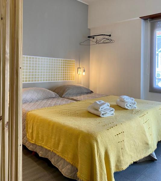 1 dormitorio con 2 camas y una mesa con toallas en Mono Celeste en Tandil
