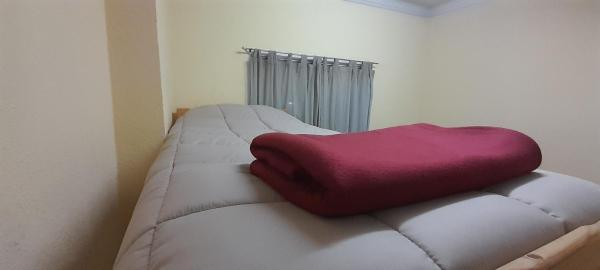 Una cama o camas en una habitación de Hostel Arrayan