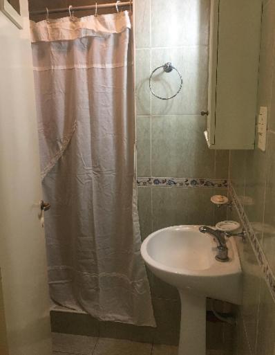 baño con lavabo y cortina de ducha en MONOAMBIENTE CENTRICO AMOBLADO en San Juan