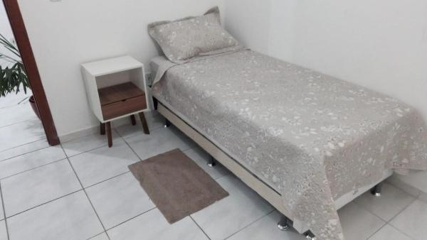 A bed or beds in a room at Apartamento a poucos minutos do Aeroporto de Floripa e das Praias do Sul da Ilha
