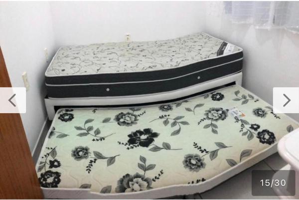 A bed or beds in a room at Apartamento a poucos minutos do Aeroporto de Floripa e das Praias do Sul da Ilha