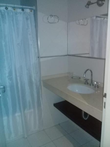 baño con lavabo y cortina de ducha en TORRES DEL TUCUMAN I en San Miguel de Tucumán