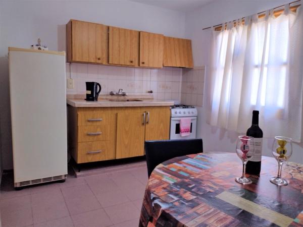 cocina con mesa y botella de vino en Departamento en Mendoza para Linda Estadía en Mendoza