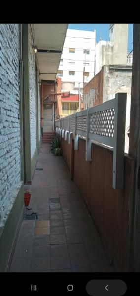 un pasillo vacío de un edificio con una valla en CARMENSITA DEPTO a 2 cuadras de BELGRANO Y 9 DE JULIO antiguo y clasico edificio de San Telmo acceso 2do piso por escalera en Buenos Aires