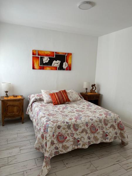 1 dormitorio con 1 cama y una pintura en la pared en Hermoso departamento en zona residencial y polo cervecero en Mar del Plata