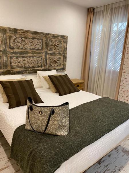 Cama o camas de una habitación en Apartamentos Sevilla Palace