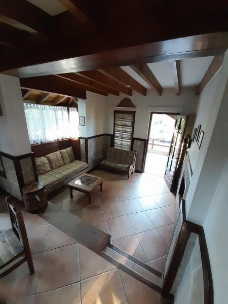 un salón con un sofá y una mesa en Cabañas Altamar en Villa Gesell