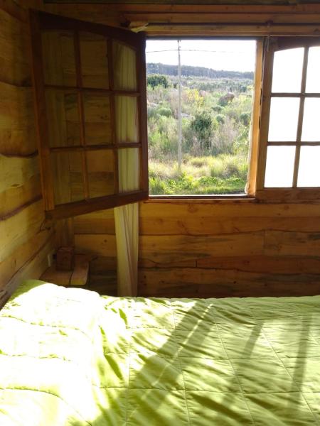 Una cama o camas en una habitación de Casa Ecológica Rama & Cabaña Rústica