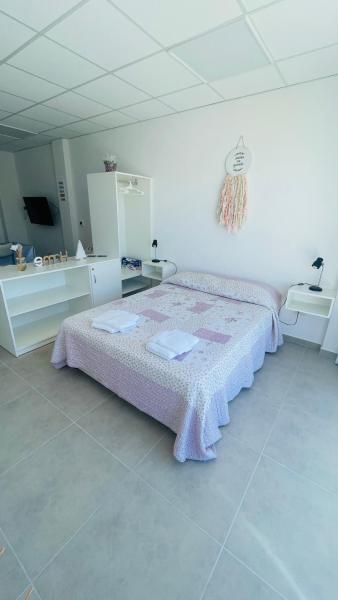 1 dormitorio con 1 cama grande con manta rosa en VYQ - Puerto Madryn Centro en Puerto Madryn