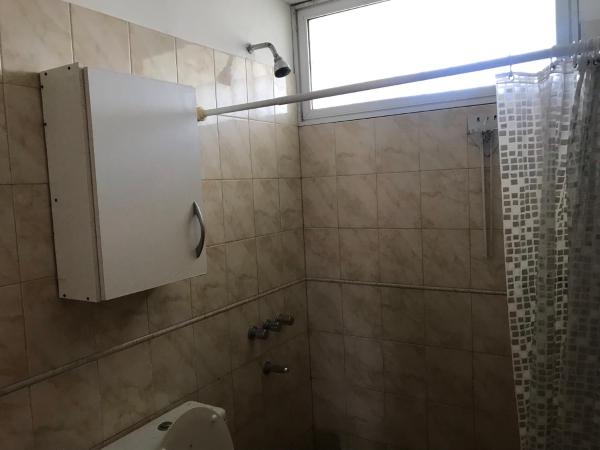 baño con ducha, aseo y ventana en Playa 497 en Pinamar