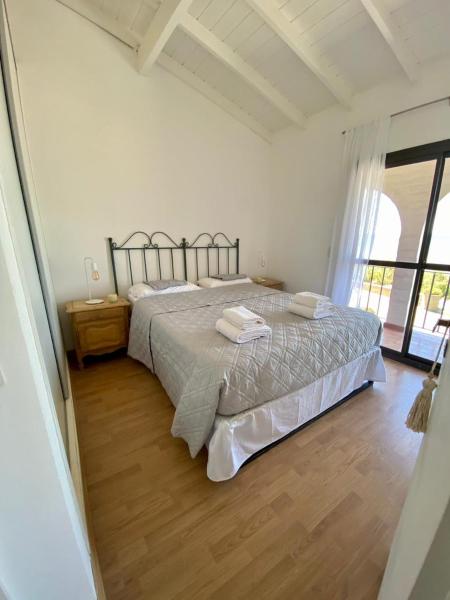 1 dormitorio con 1 cama con 2 toallas en DUPLEX frente al mar - Puerto Madryn Vacation Rentals en Puerto Madryn