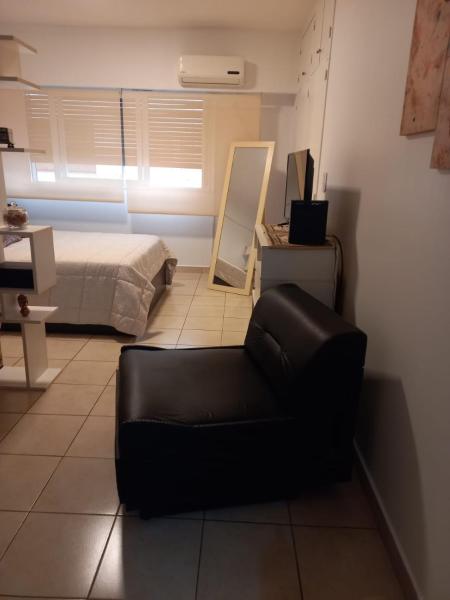 sala de estar con silla negra y cama en Excelente monoambiente en Retiro en Buenos Aires
