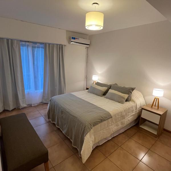 1 dormitorio con 1 cama grande y 2 lámparas. en La Jarilla en Mendoza