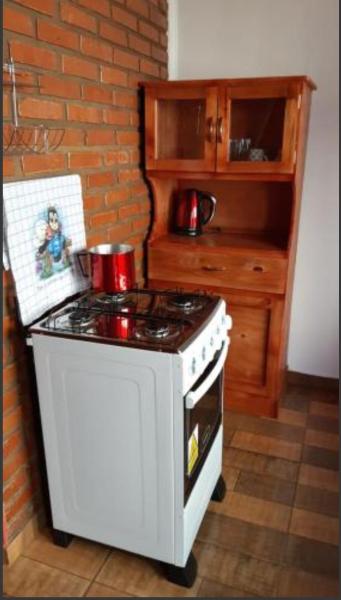 cocina con fogones blancos y encimera en Duplex Victoria, Puerto Iguazú en Puerto Iguazú