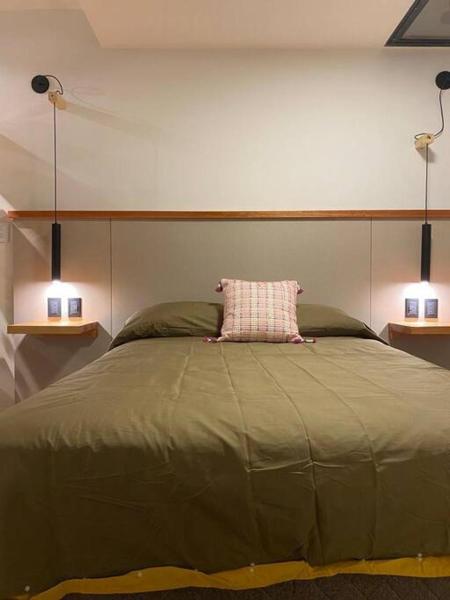 Un dormitorio con una cama grande con una almohada. en Brand new - Cozy Apartment- En el corazon de Mendoza en Mendoza