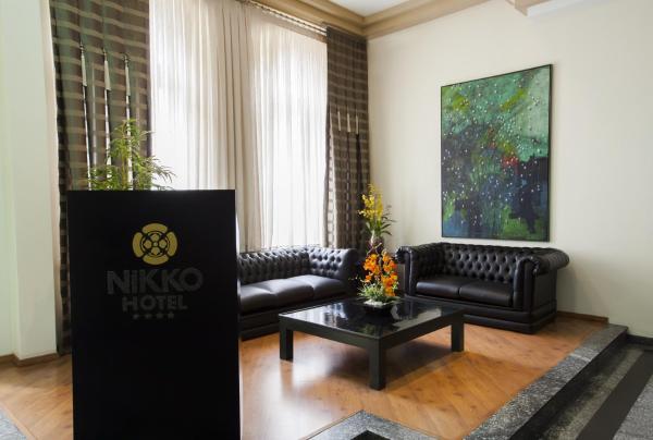 a living room with a couch and a table at Hotel Nikko in Curitiba