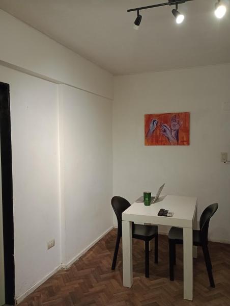 una mesa blanca con sillas y una pintura en la pared en Departamento en Recoleta en Buenos Aires