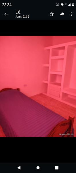 Habitación rosa con cama y escalera en CELRIOS Departamento en Puerto Madryn