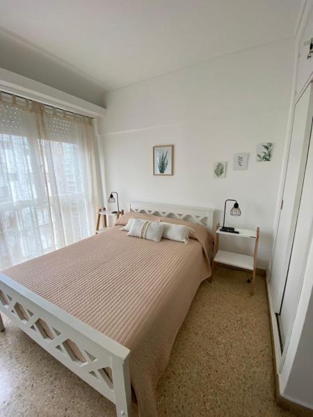 Un dormitorio blanco con una cama grande y una ventana en Alojamiento Calma en Mar del Plata