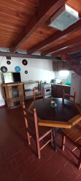 cocina con mesa y sillas en una habitación en Cabañas Tres Ríos Vacacional en Villa Cura Brochero