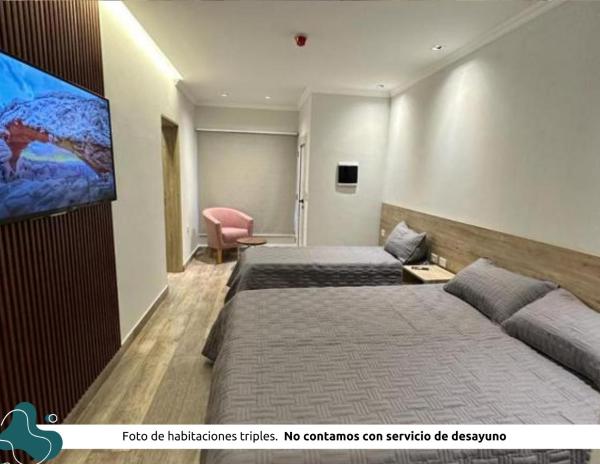 Habitación de hotel con 2 camas y Tv LED. en Z Hotel Boutique en Puerto Iguazú