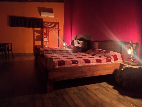 1 dormitorio con 2 camas en una habitación con iluminación roja en Quinta Don Adolfo en Puerto Iguazú