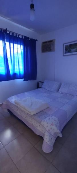 1 cama grande en un dormitorio con ventana azul en Las Colinas en Salta