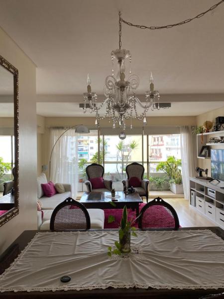 sala de estar con mesa de comedor y lámpara de araña. en Grand Juncal apartment Recoleta en Buenos Aires