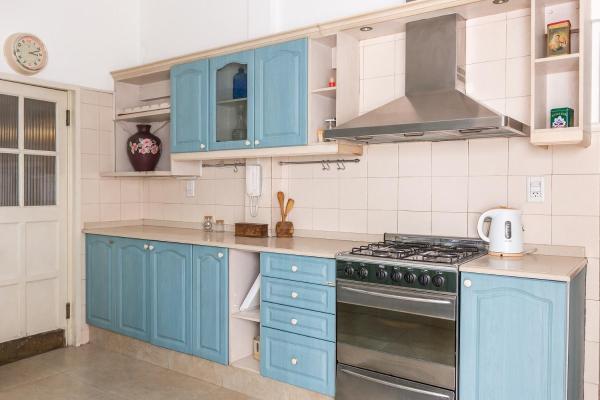 cocina con armarios azules y fogones en Casa Magnolia by Vilvey Turismo en Mendoza