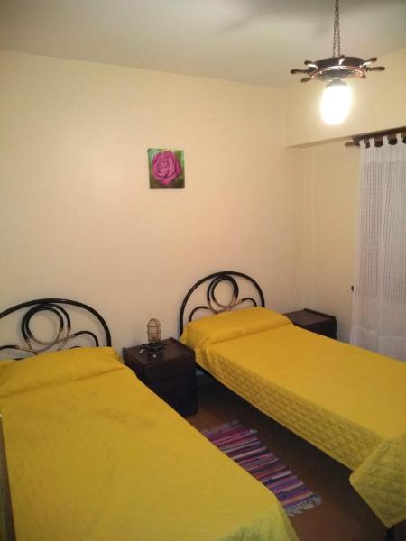 2 camas en una habitación con sábanas amarillas en Edificio marisol en Villa Gesell