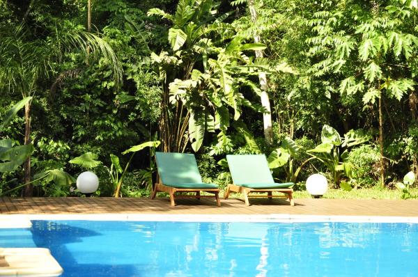 2 sillas sentadas junto a una piscina en Tierra Guaraní Lodge en Puerto Iguazú