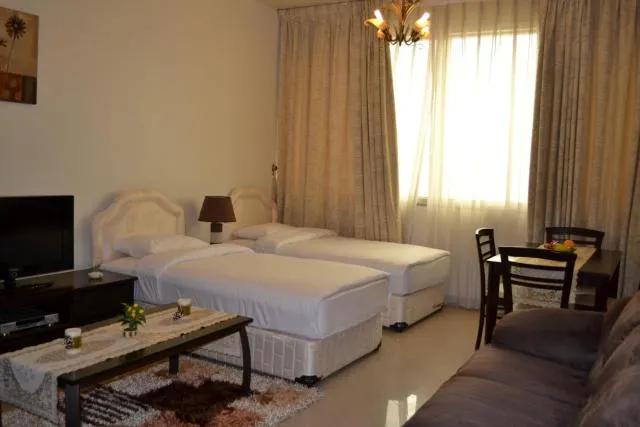  Abu Dhabi Plaza Hotel Apartments - picture  : TV/entertainment centre,Bed,Day,Photo of the whole room,Room 