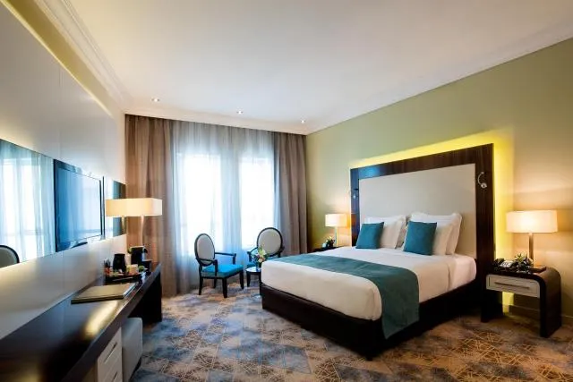  Elite Byblos Hotel - picture  : Bed,TV and multimedia,Coffee/tea facilities,Living room,Photo of the whole room,Decorative detail,Seating area,Bedroom,Property,Room 