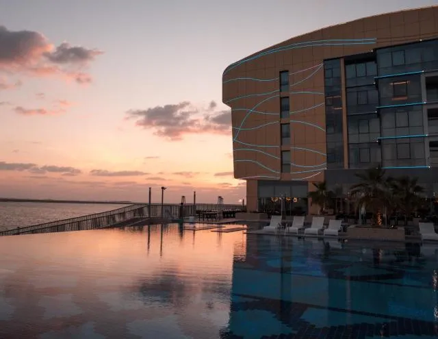  Royal M Hotel & Resort Abu Dhabi - picture  : Property building,Swimming pool,Sunrise/sunset,Landmark view,Pool view,Sea view,Property 